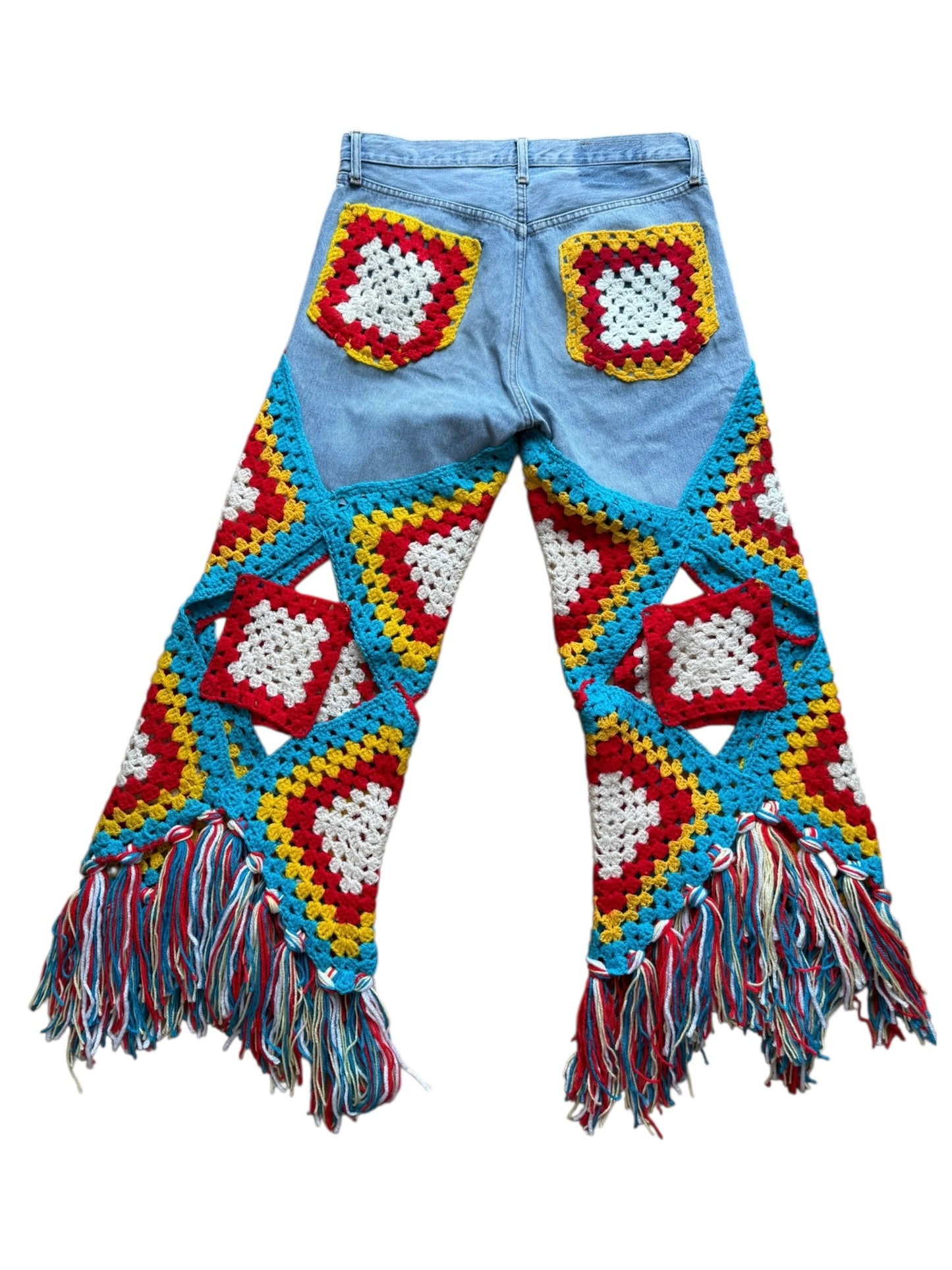 Colorful crochet pants with fringes on a white background
